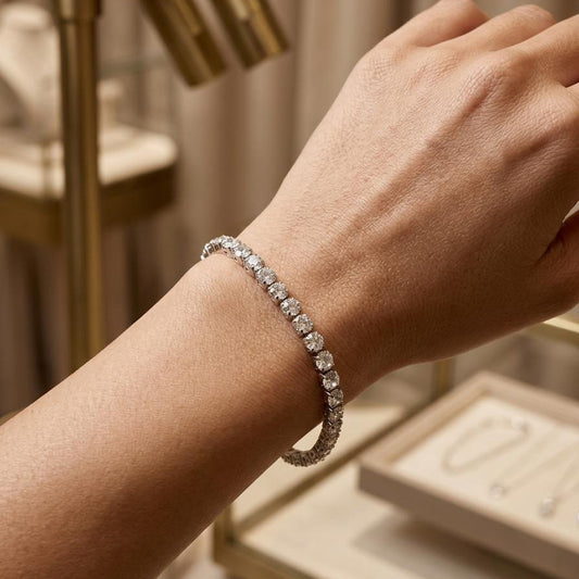 Close-up of a hand wearing a diamond bracelet with a blurred background