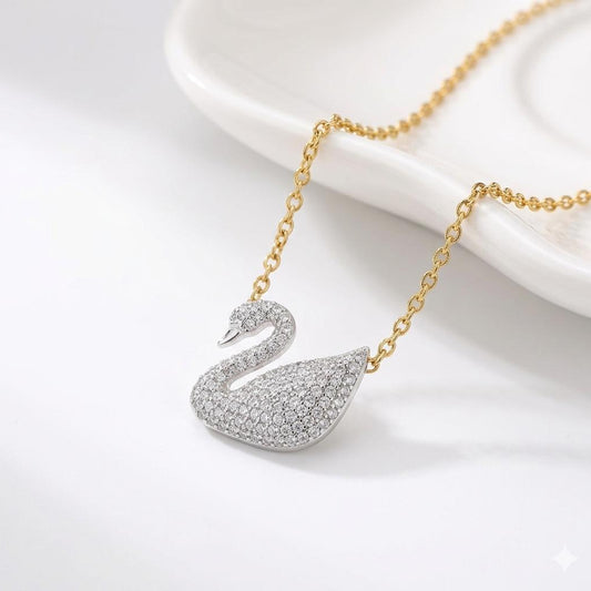 Gold necklace with a swan pendant on a white background
