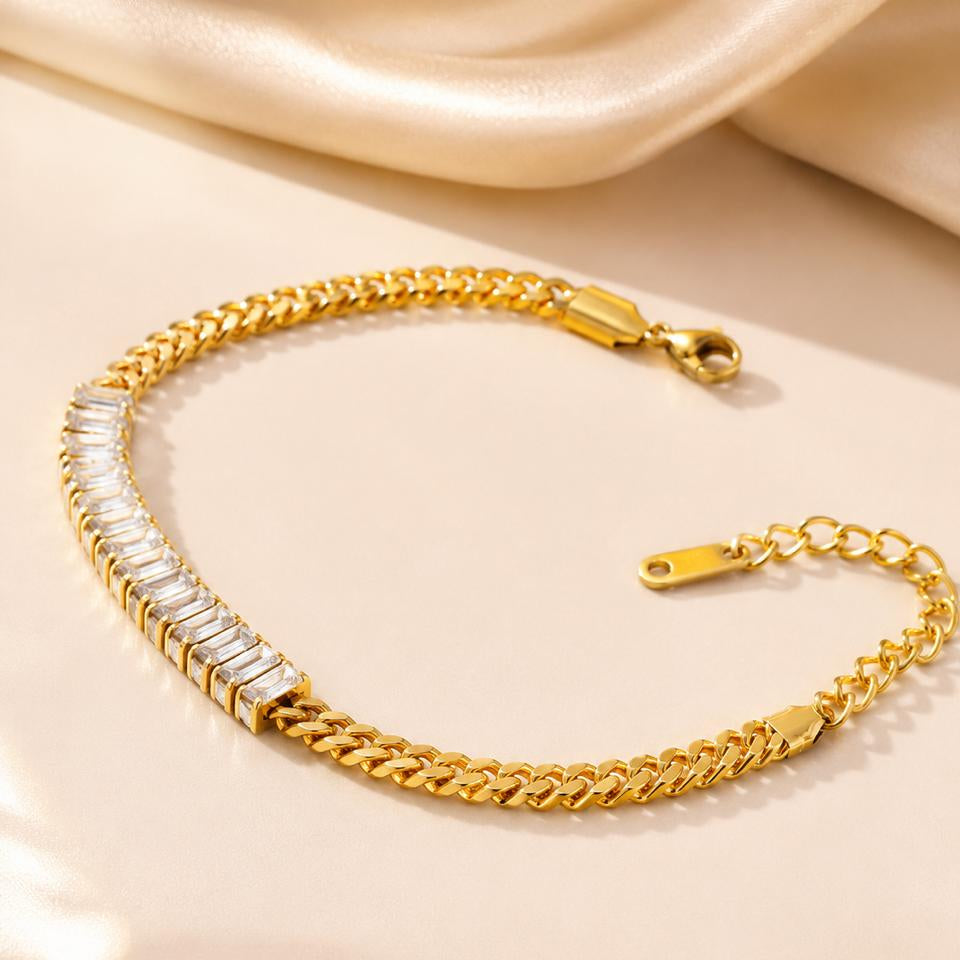 Gold bracelet with clear stones on a beige fabric background